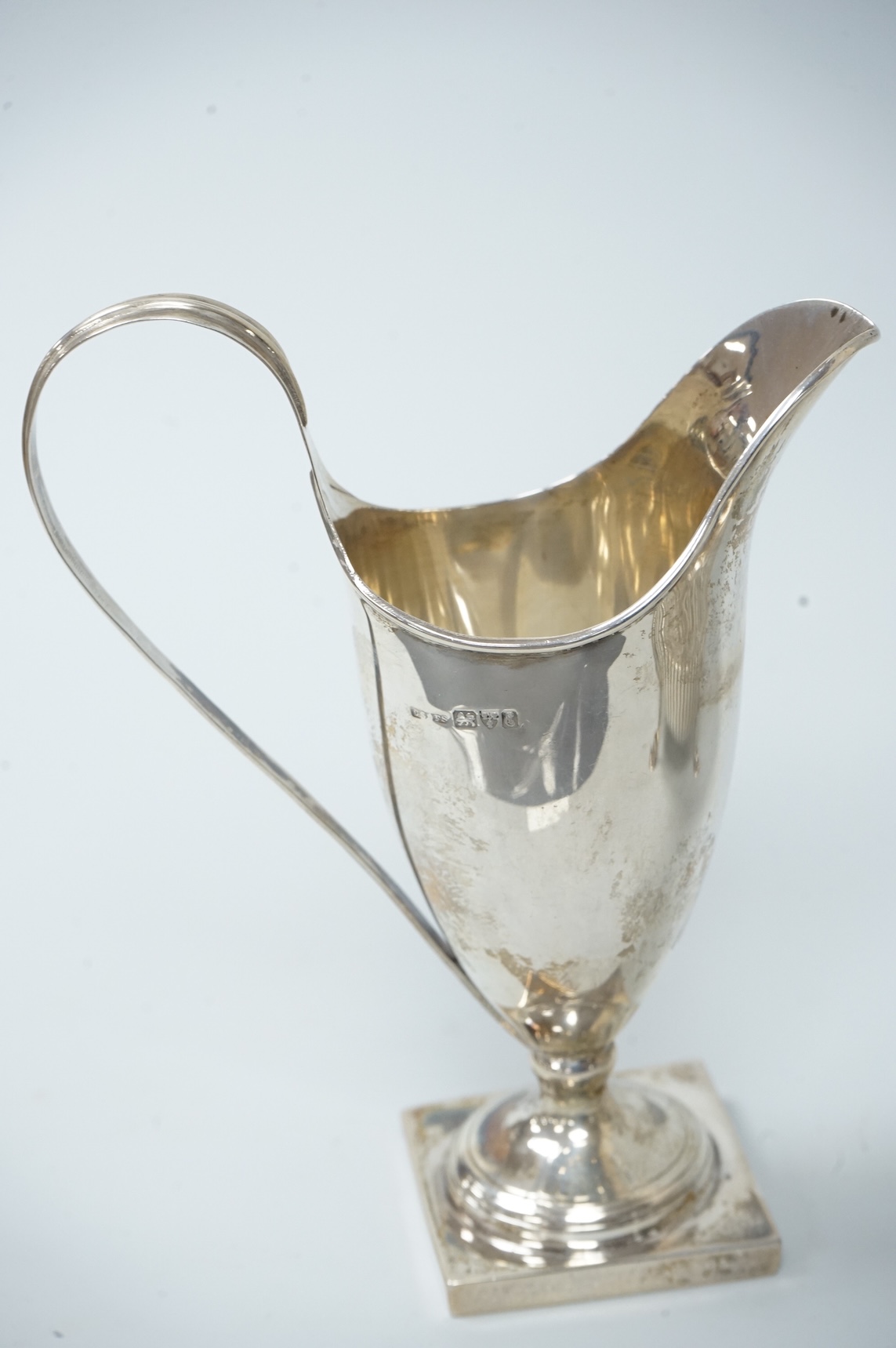 A late Victorian silver sugar basin, by Robert Harper, London, 1879, diameter 13.2cm, together with an Edwardian silver helmet shaped cream jug, Saunders & Shepherd, Chester, 1905, 15cm, 9.1oz.